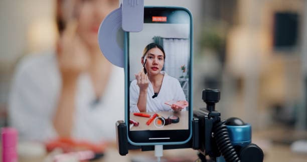 Influencer in focus while applying makeup