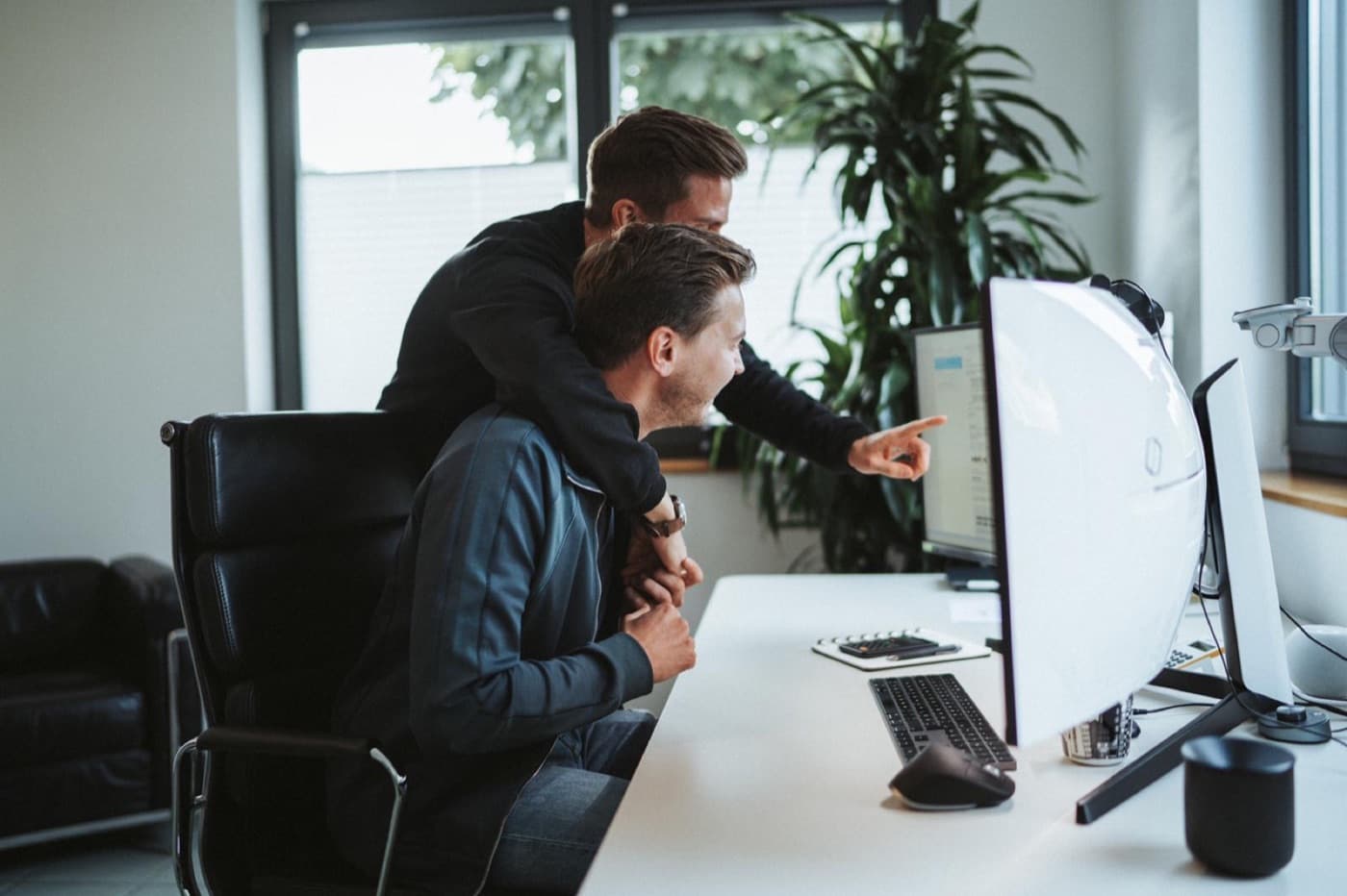 Two team members at a desk in the office