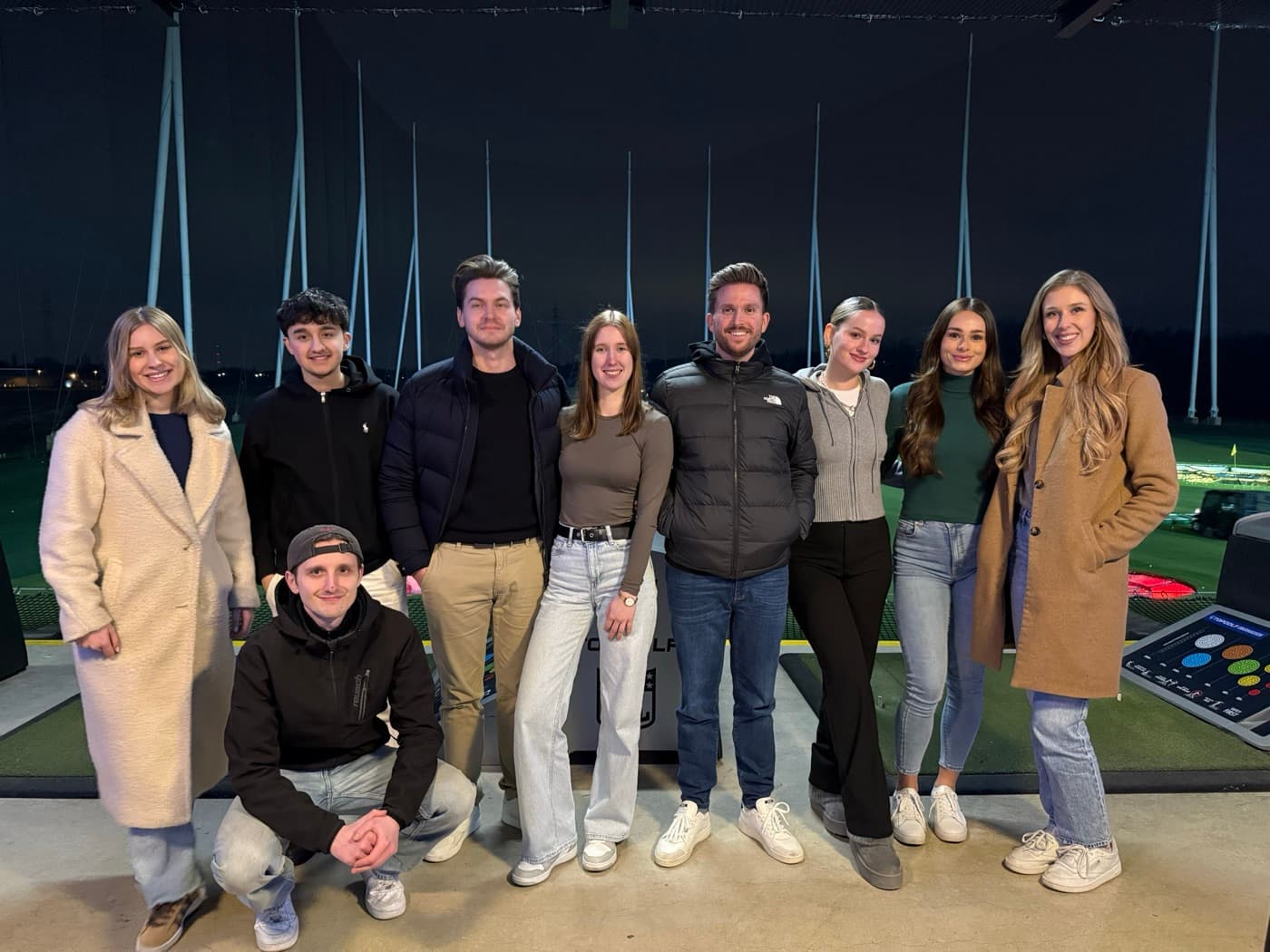 The team at an indoor golf event